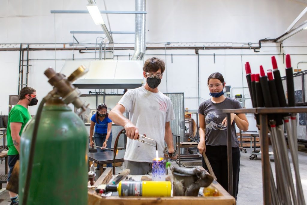 At Slow Burn Glass studio in Richmond, owner Bryan Goldenberg instructs students in the art of glassblowing.